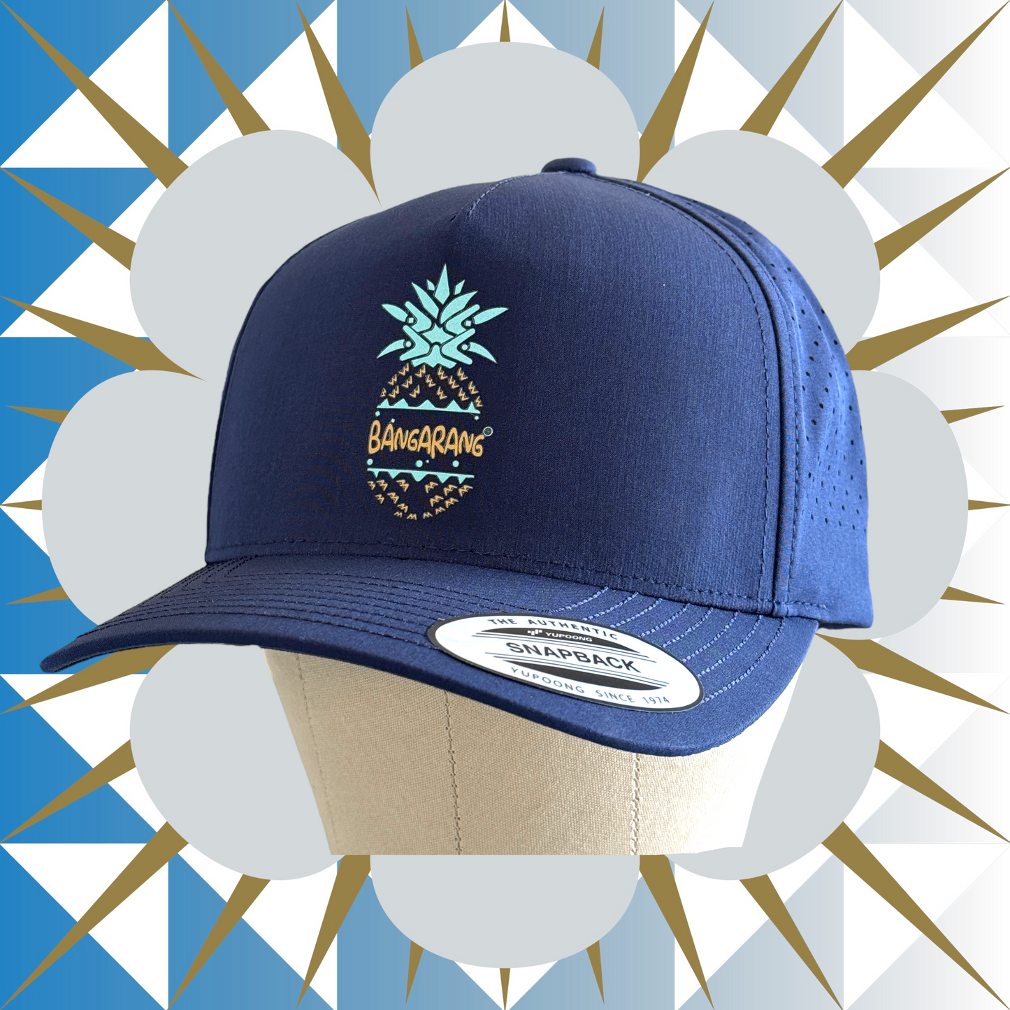 Navy blue cap with pineapple design on a decorative background